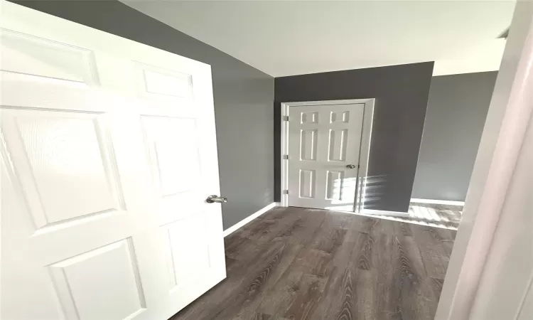 Hallway with dark wood-type flooring