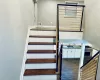 Staircase featuring hardwood / wood-style floors and sink