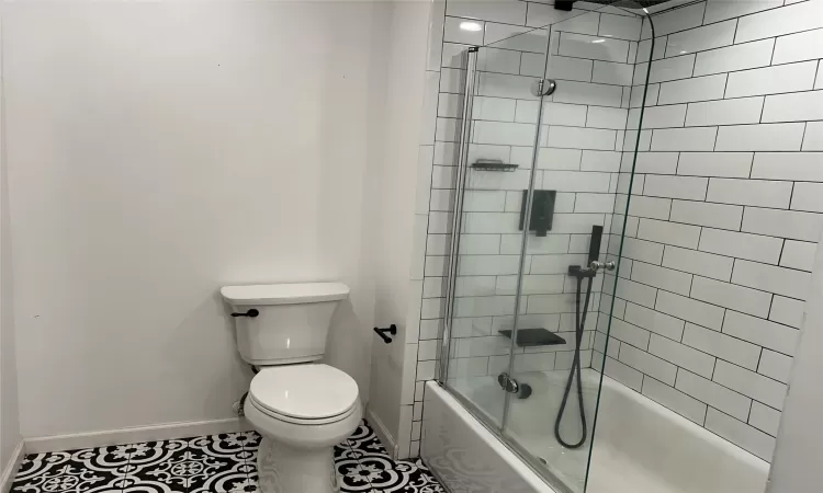 Bathroom with tile patterned tile flooring, tub / shower combo