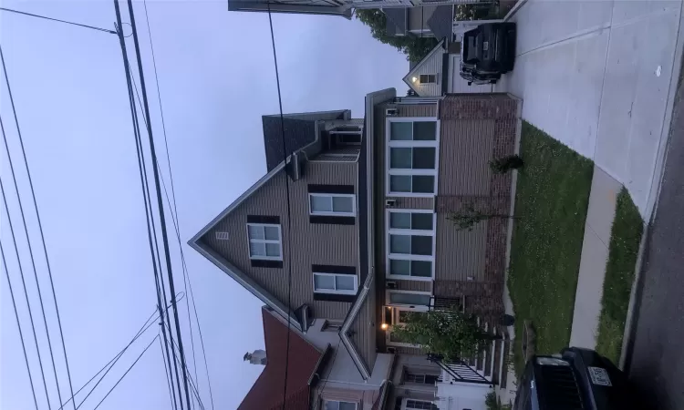 View of front of home featuring an outbuilding and a garage