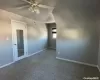 Empty Bed room with carpet and ceiling fan