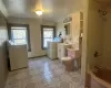 Full bathroom featuring tile patterned floors, lofted ceiling, separate washer and dryer, and vanity