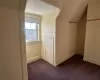 Spacious closet with dark colored carpet