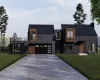 Contemporary home featuring a garage and a front lawn