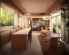 Dining room featuring a multi sided fireplace, built in shelves, dark carpet, and sink