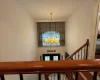 Stairway featuring a chandelier and a towering ceiling