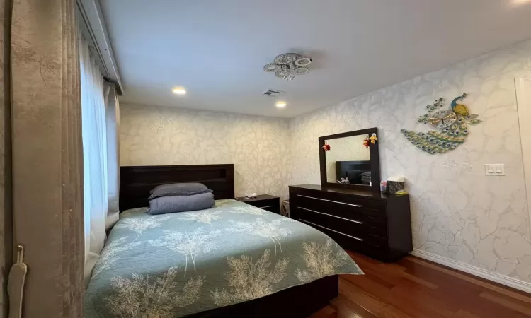 Bedroom with dark wood-type flooring