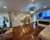 Living room with dark wood-type flooring and ornamental molding