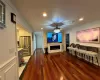 Home theater featuring hardwood / wood-style flooring and ornamental molding