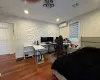 Bedroom featuring a wall mounted AC and dark hardwood / wood-style floors