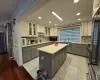 Kitchen featuring gray cabinetry, white cabinetry, sink, and premium appliances