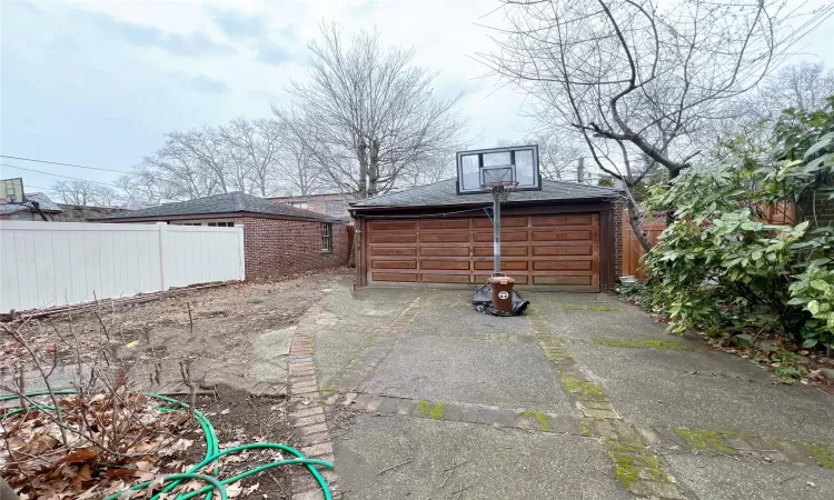 View of patio / terrace with an outdoor structure and a garage