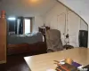 Bedroom featuring wood-type flooring, a textured ceiling, and vaulted ceiling