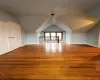 Bonus room with vaulted ceiling and hardwood / wood-style flooring