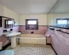 Bathroom with tile walls, tile patterned floors, and a bathing tub