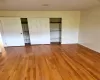 Unfurnished bedroom featuring wood-type flooring and a closet