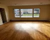 Unfurnished room with a baseboard heating unit and light hardwood / wood-style flooring