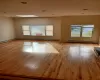 Unfurnished room featuring light wood-type flooring and baseboard heating