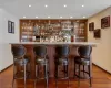 Bar featuring hardwood / wood-style flooring