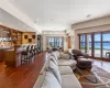 Living room featuring dark hardwood / wood-style floors, a water view, and bar area