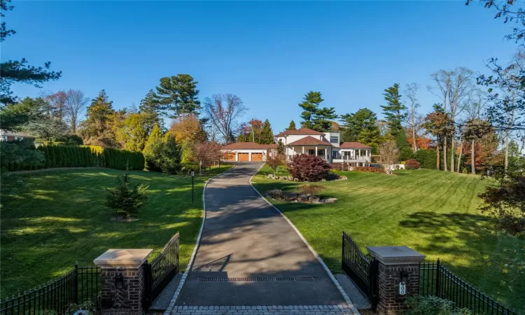 Ranch-style home featuring a front lawn and a garage