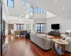 Living room featuring a high ceiling, dark hardwood / wood-style floors, and french doors