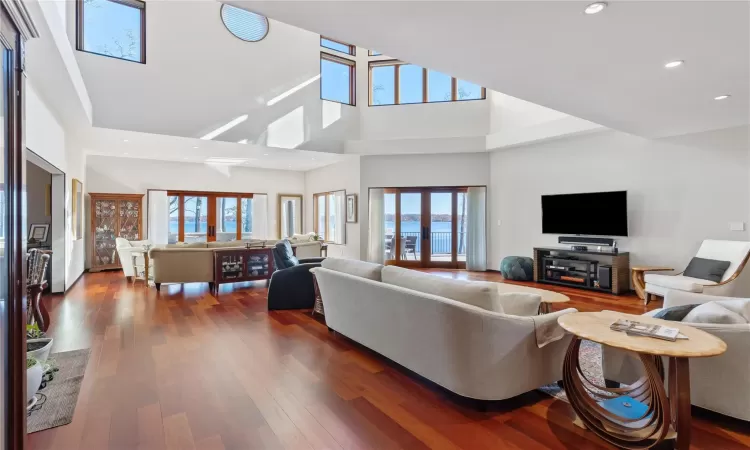 Living room featuring a high ceiling, dark hardwood / wood-style floors, and french doors