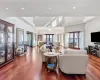 Living room with french doors, a high ceiling, and hardwood / wood-style flooring