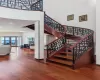 Staircase featuring wood-type flooring and a high ceiling