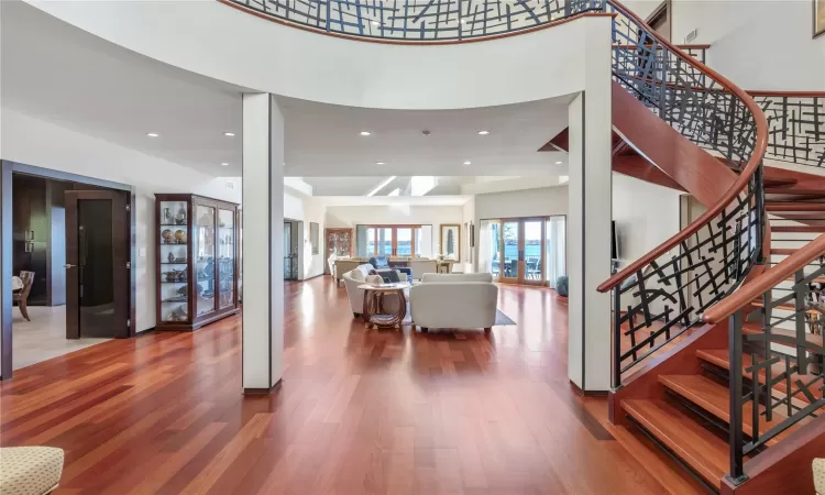 Entryway with wood-type flooring and a high ceiling