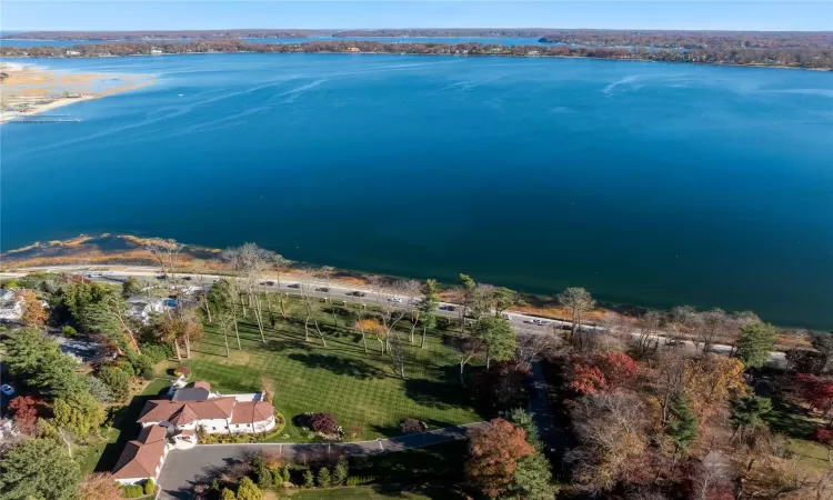 Birds eye view of property with a water view