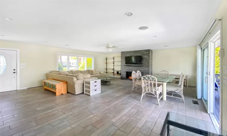 Living room with ceiling fan and a fireplace