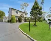 View of front of home featuring a shed and a front lawn