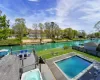 View of pool with a deck with water view