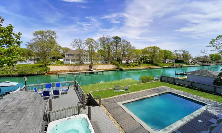 View of pool with a deck with water view