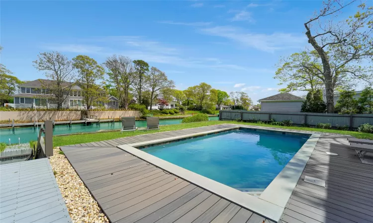 View of pool featuring a deck with water view