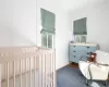 Bedroom featuring a nursery area and hardwood / wood-style floors