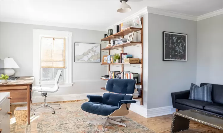 Office featuring light hardwood / wood-style flooring and crown molding