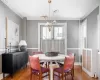 Dining area with wood-type flooring and ornamental molding