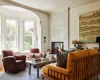 Sitting room featuring a multi sided fireplace and crown molding