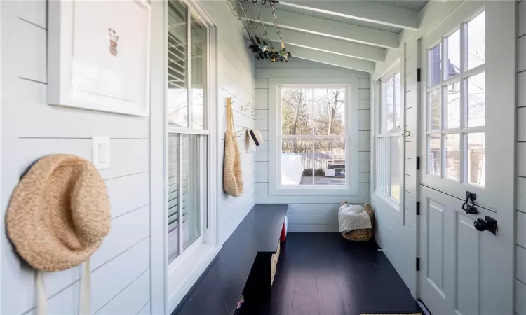 Sunroom featuring wooden ceiling and vaulted ceiling with beams