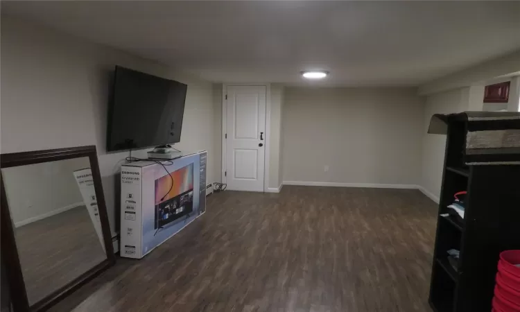 Living room with dark hardwood / wood-style flooring