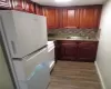 Kitchen with white refrigerator, range, sink, and tasteful backsplash