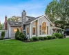 Back of property with a gazebo, a patio area, and a lawn