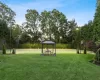 Back of property featuring a gazebo and a lawn