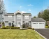 View of front of property featuring a garage and a front yard