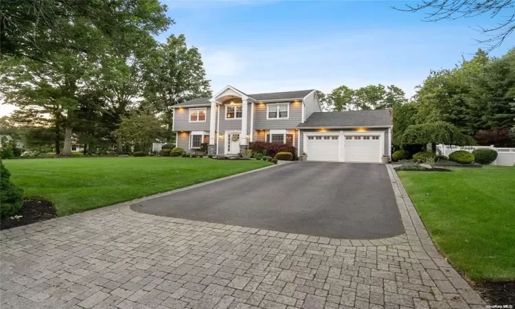 View of front property with a front lawn and a garage