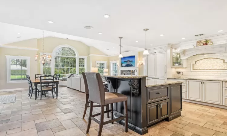 Dining room with light wood-type flooring, crown molding, a baseboard radiator, and a chandelier