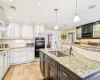 Dining space with baseboard heating, crown molding, light wood-type flooring, and an inviting chandelier