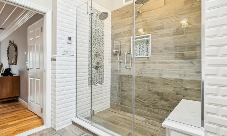 Bedroom featuring hardwood / wood-style flooring, ceiling fan, and crown molding